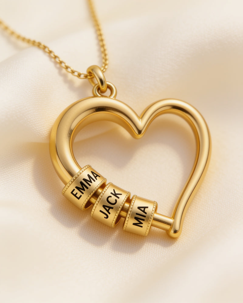 Close-up of the engraved gold name beads on the Heart of the Family necklace