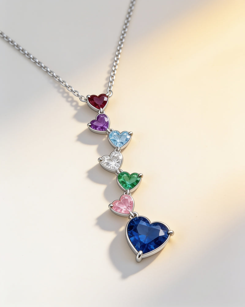 Birthstone Heart Cascade Necklace in silver with seven different birthstone hearts and an off-centre drop heart