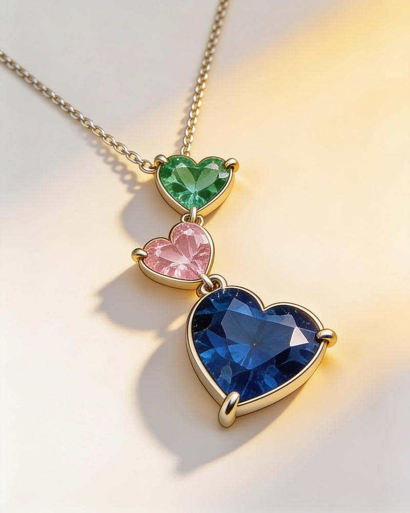 Birthstone Heart Cascade Necklace in gold with three birthstone hearts: emerald, pink and a sapphire-blue drop heart