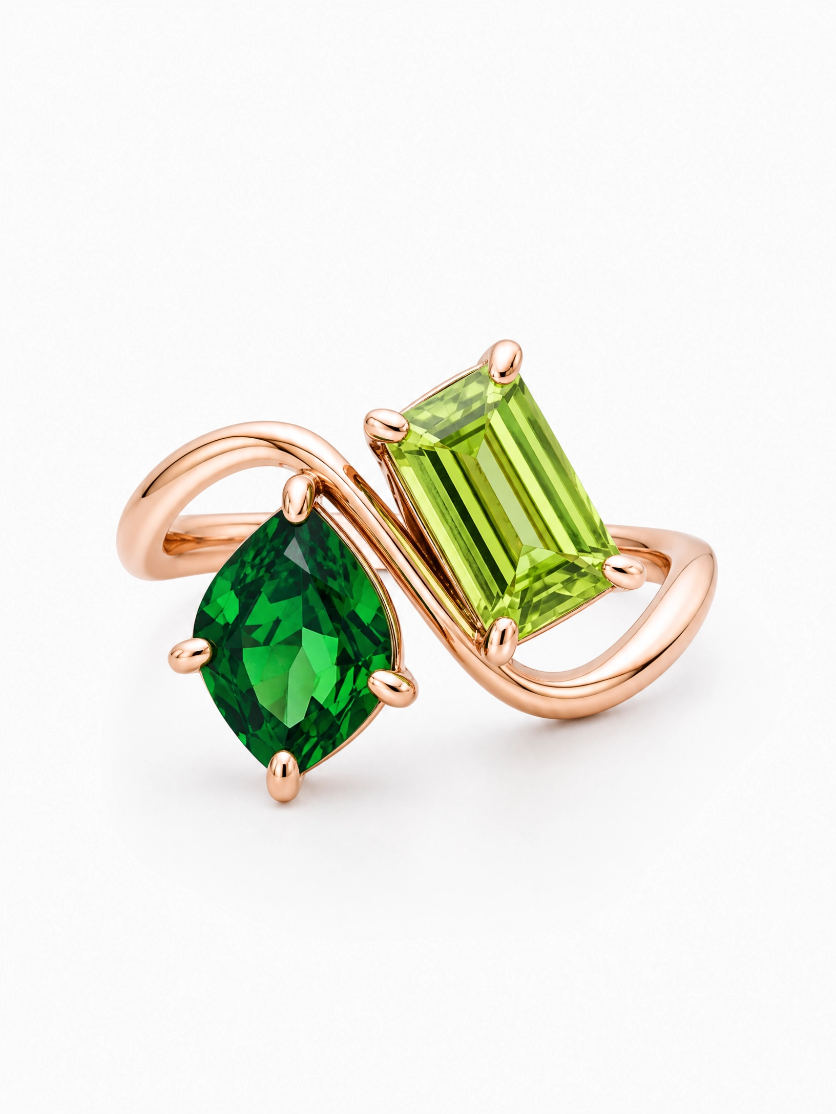 Personalized two-birthstone ring in rose gold with emerald and peridot stones on a flowing band